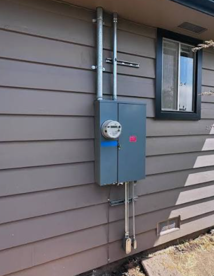 A combination meter and main breaker panel on an exterior wall.
